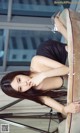 A woman sitting on top of a couch next to a table.